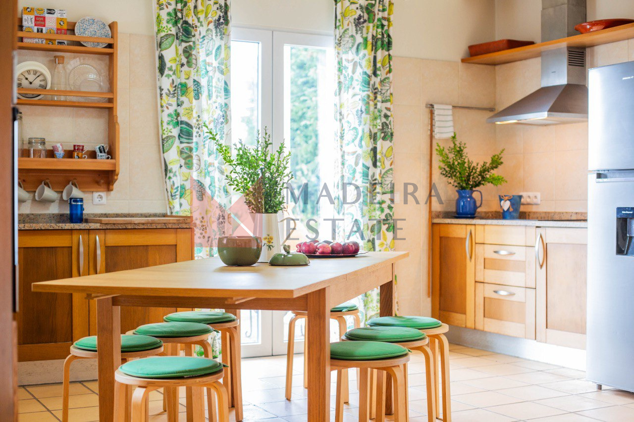 Spacious fully equipped kitchen with a dining table in a luxury villa for rent in Madeira