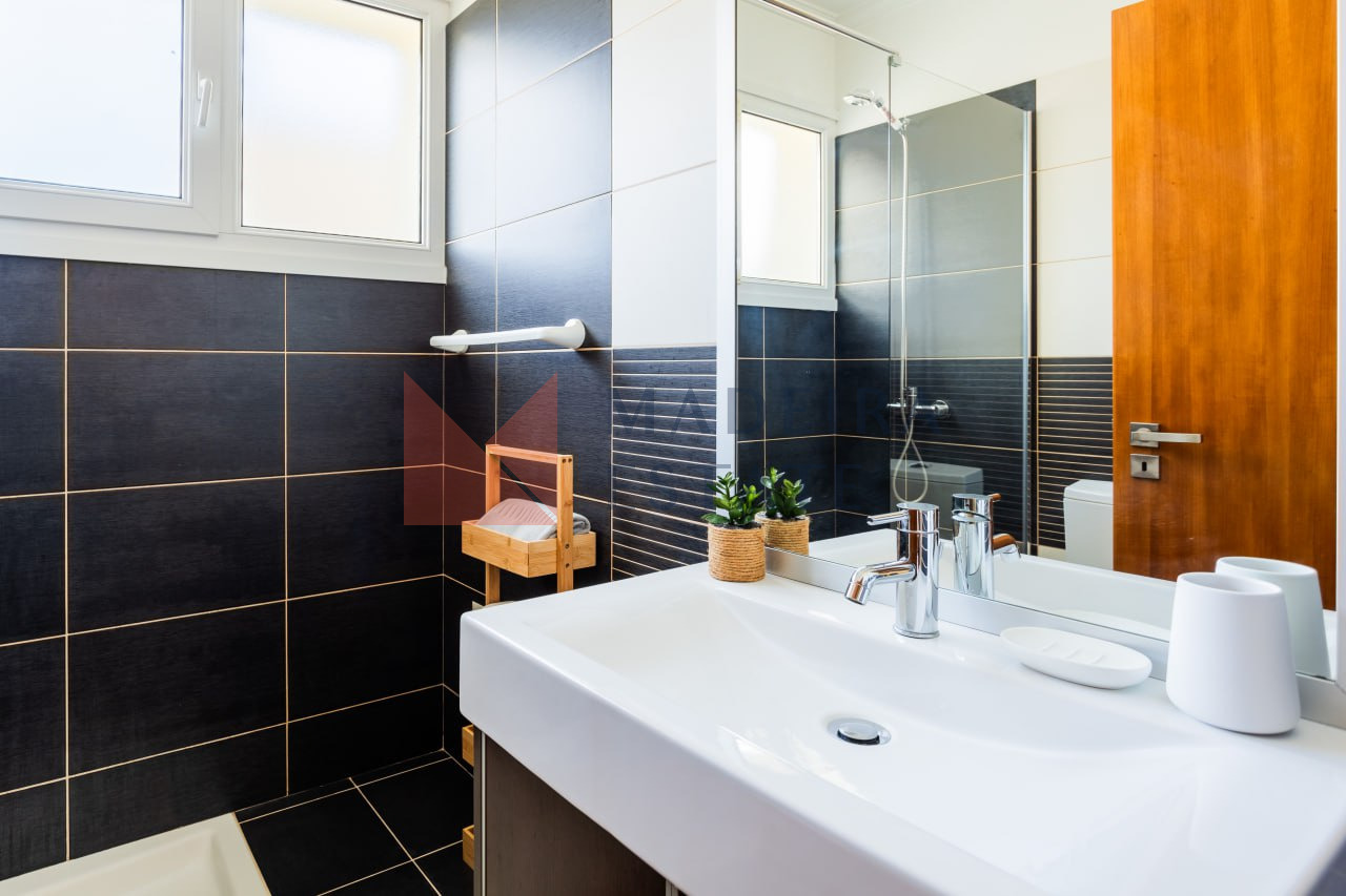 Modern bathroom with stylish black tiles in vacation rental home in Madeira
