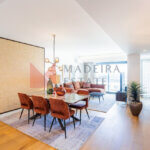 Modern short-term rental living room with panoramic windows and ocean view in Funchal
