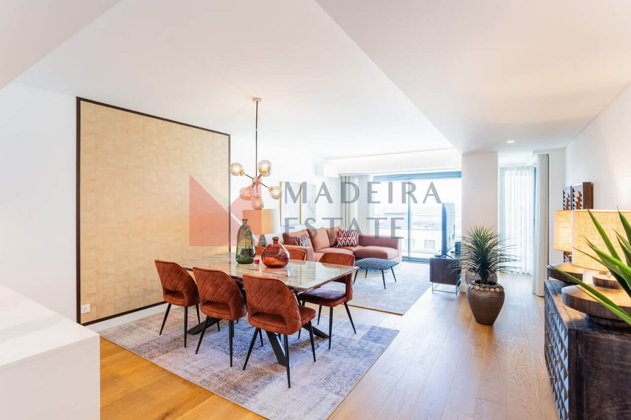 Modern short-term rental living room with panoramic windows and ocean view in Funchal